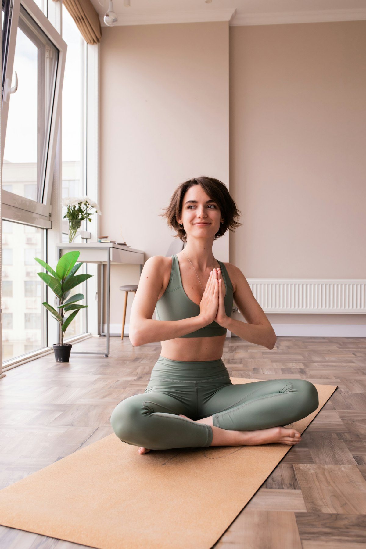 Woman relaxing on a yoga mat at home